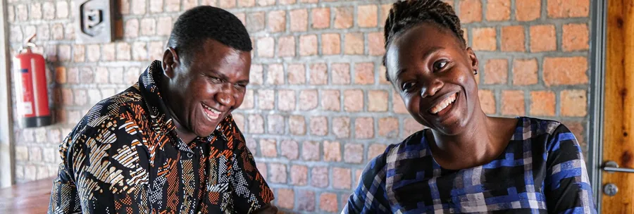 Two Cherish Uganda staff laughing together